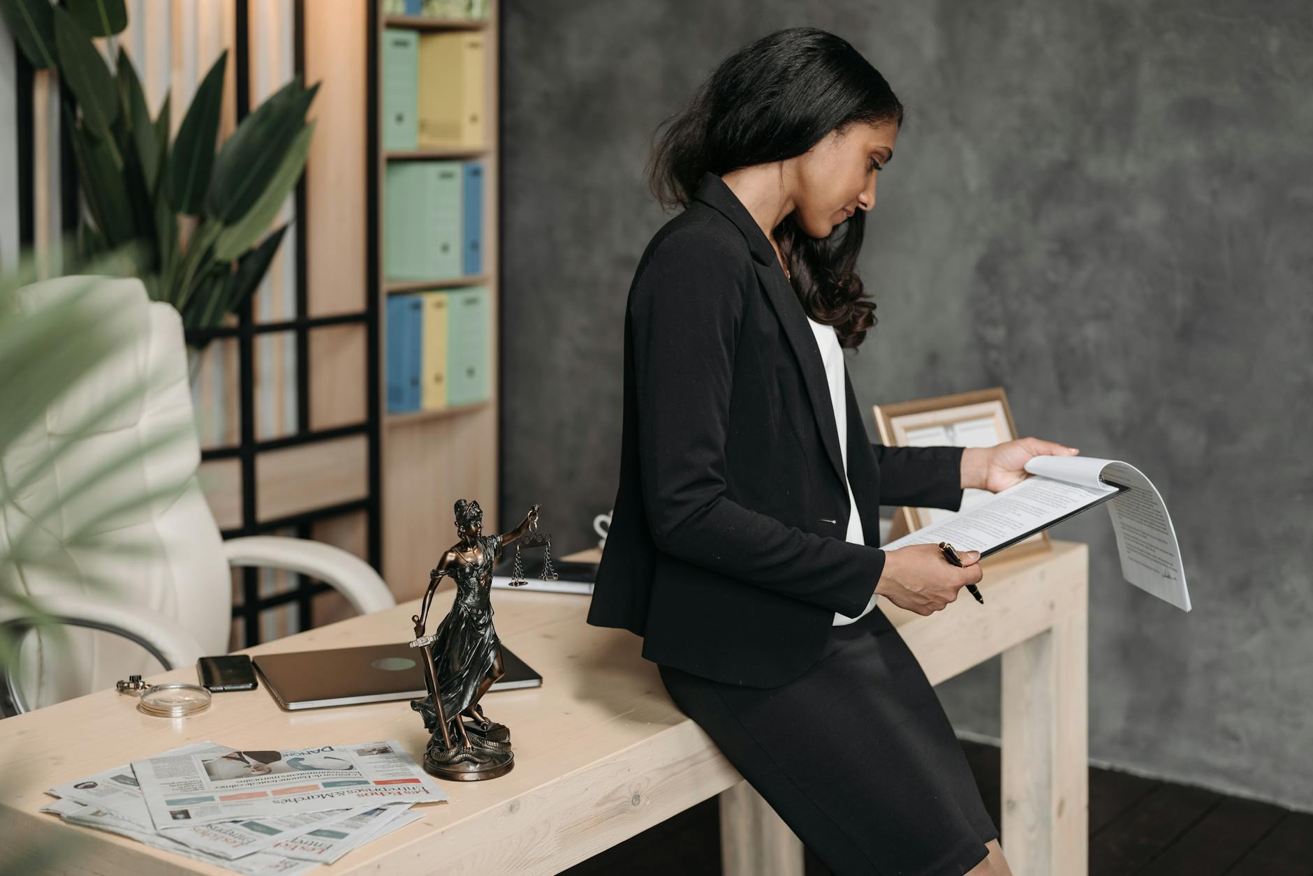Paralegal organizing legal case files in modern law office